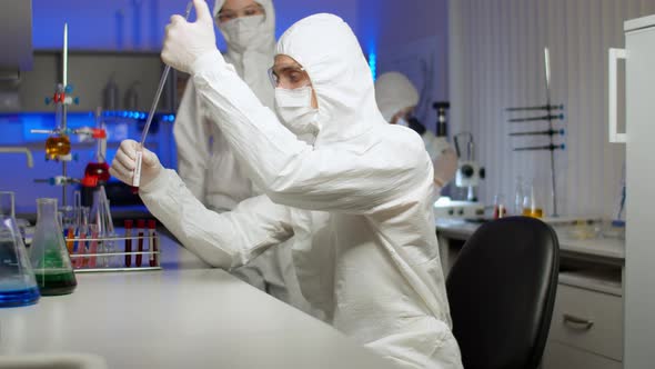 Biologist Examining Sample in Laboratory