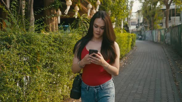 a Beautiful Trans Woman Chatting While Walking Down the Street