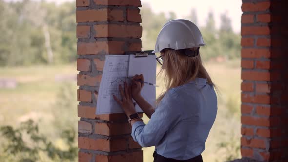 Real Estate Building Project Manager. Woman Architect In Helmet Inspecting Building. Civil Engineer.