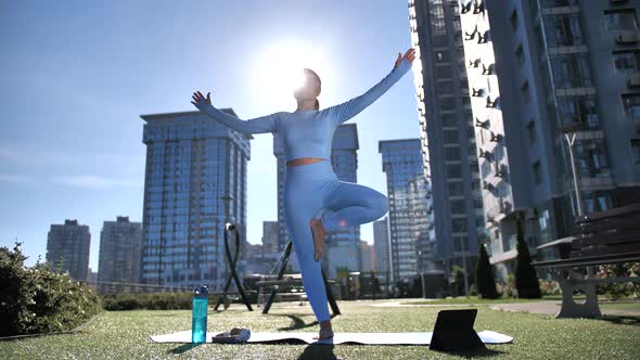 Sporty Female Practicing Yoga on Urban Playground