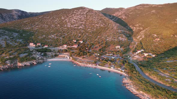 Aerial View of the Rocky Coast of Croatia with a Curve Road at Sunset Time