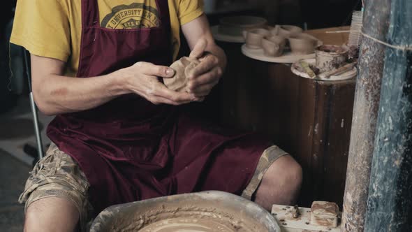 Potter Shapes the Clay Product with Pottery Tools on the Potter's Wheel Top View Toned Cinematic