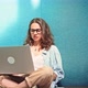 A Young Woman Wearing Glasses Leading a Video Call with Colleagues on Her Laptop - VideoHive Item for Sale