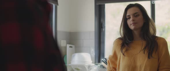 Couple having a serious conversation about their relationship in the kitchen