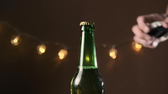 Close Up of Hand of Man Opening a Beer Bottle