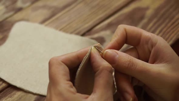 Women Sews a Cute Cloth Doll