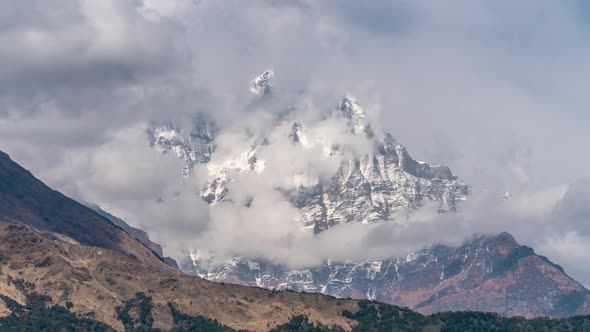 Snow Mountain Peak Among Moving Clouds in the Himalayas in Nepal. Timelapse