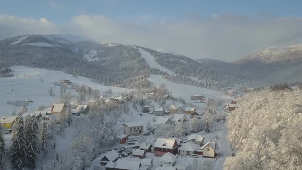 Mountain Village in Snow From a Height, Flight Over a Village in Carpathian Mountains in Winter