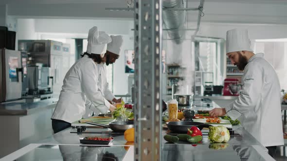 Professional Chef Frying Organic Vegetables on Kitchen Stove