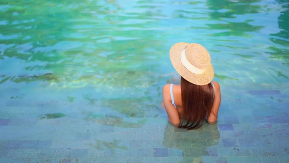 Young asian woman enjoy around outdoor swimming pool for leisure