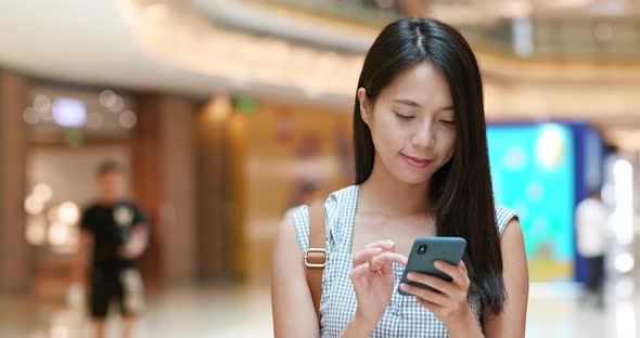 Woman use of cellphone in shopping mall