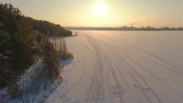 Flight Over a Taiga Forest Lake in Winter