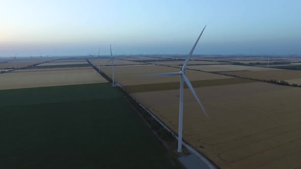 Landscape with Windmills and Farm Fields at Dusk. Aerial Survey