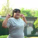 Happy overweight Asian women are warm-up before exercising in the park - VideoHive Item for Sale