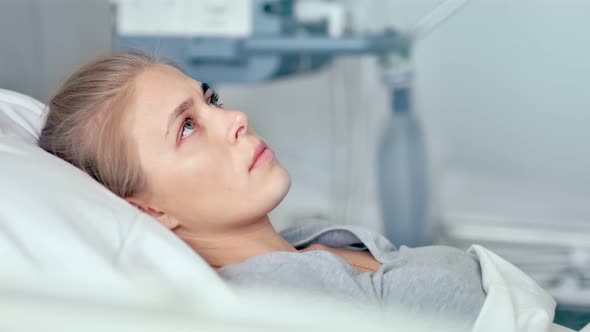 Young Female Patient Lying in a Hospital Room