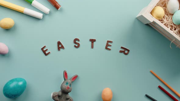 Easter Text on a Blue Background with Colored Eggs