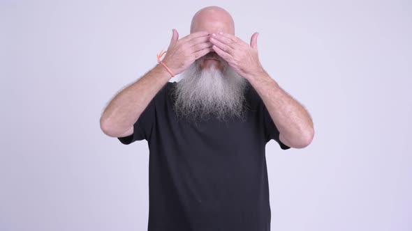 Mature Bald Bearded Man Covering Eyes As Three Wise Monkeys Concept