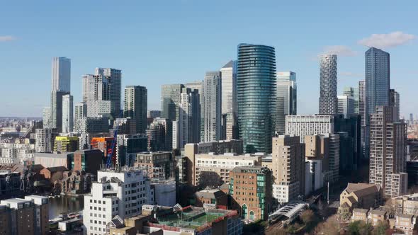 Rising drone shot of canary wharf skyscrapers London close up sunny day