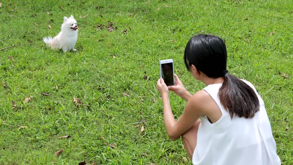 Woman taking photo on her dog