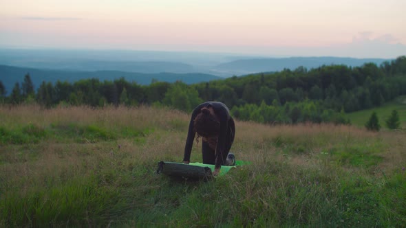 Lovely Sporty Fit African American Woman Practicing Cat Cow Yoga Asana on Mountain Hill at Sunrise