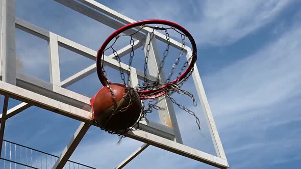 Shooting orange basketball ball into the basket