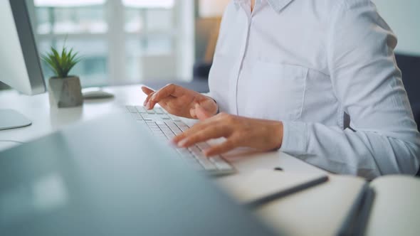 Woman with Glasses Typing on a Computer Keyboard. Concept of Remote Work.