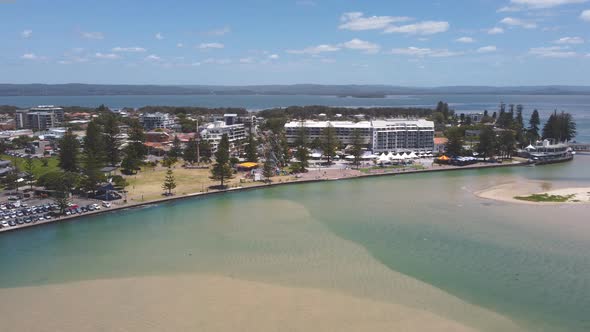 an aerial ascending midday shot of the entrance waterfront