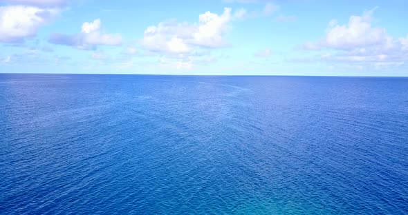 Natural overhead clean view of a sunshine white sandy paradise beach and aqua blue ocean background 