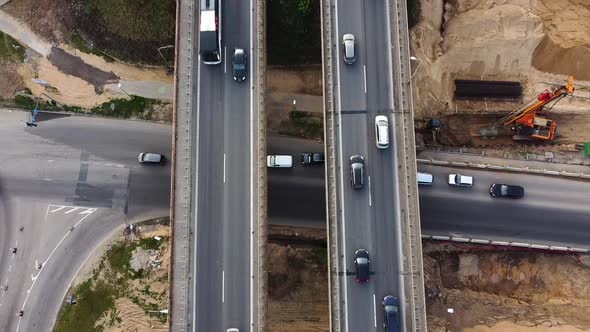 Static aerial shot of A1 highway in Kaunas in multi level intersection with a road beneath the highw