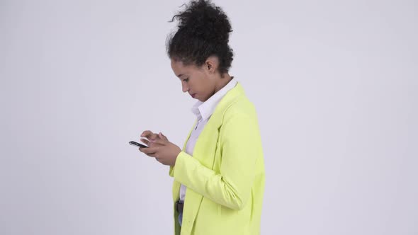 Profile View of Young African Businesswoman with Phone Being Taken Away