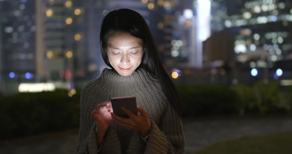 Woman use of mobile phone at night