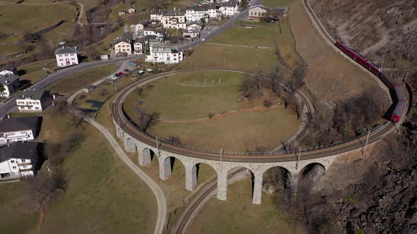 Train on Brusio Spiral Viaduct in Switzerland