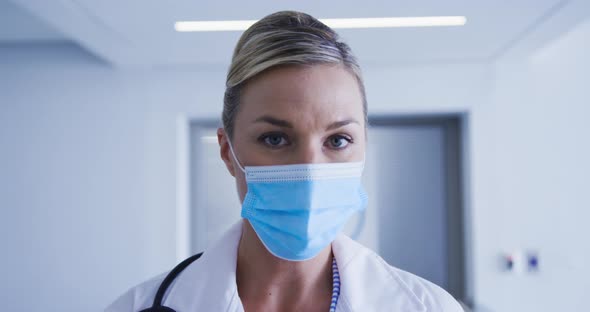 Portrait of caucasian female doctor wearing face mask