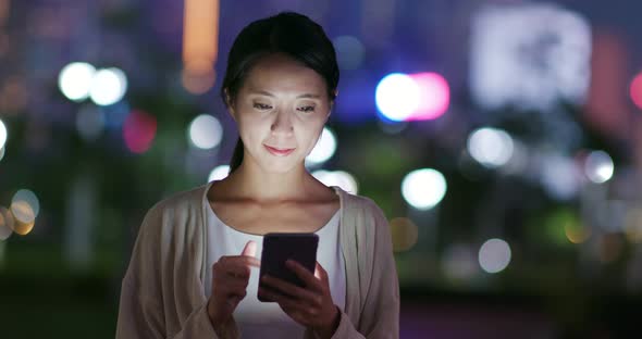 Woman Sending Sms on Smart Phone at Night