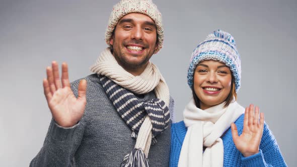 Happy Couple in Winter Clothes Waving Hands 6