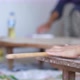 Female Hands Of Baker Rolls Dough In Flour On Wooden Board On Table With A Rolling Pin - VideoHive Item for Sale