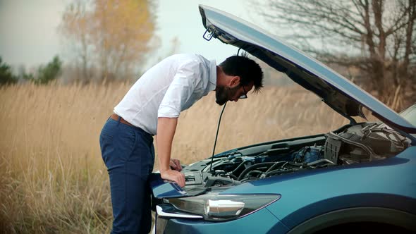 Businessman Repairing Accident Car. Man On Broken Car. Vehicle Check Engine Damage Troubles.