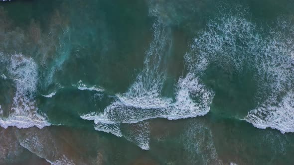 Aerial View A Big Wave Crashes Into The Shore At Karon Beach