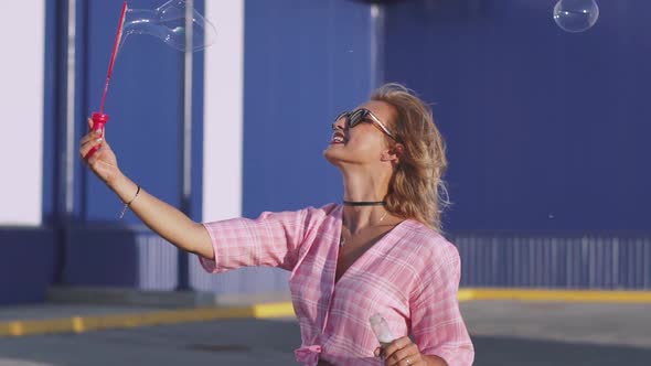 Attractive Young Woman Makes Soap Bubbles on Street  Slow Motion 120 Fps