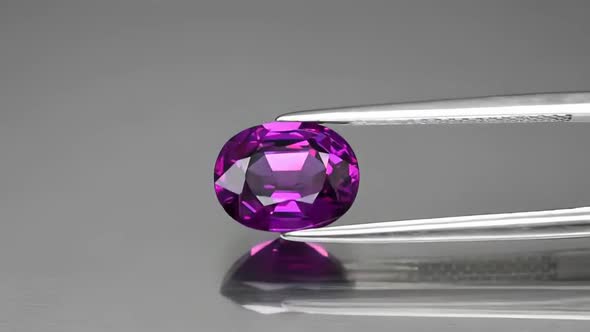 Natural Purple Malawi Garnet Oval Cut in the Tweezers