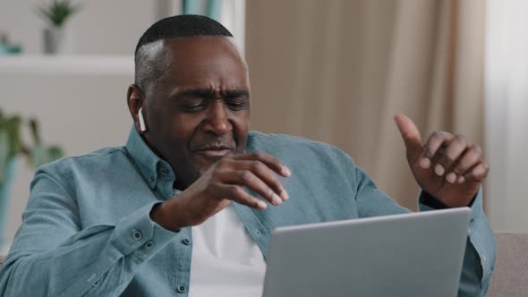 African American Businessman Freelancer Distracted From Work By Laptop Happy Man Sitting Home on