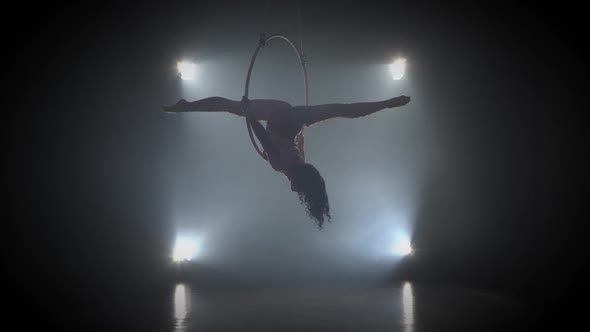 Aerial Acrobat in the Ring. A Young Girl Performs the Acrobatic Elements in the Air Ring 002