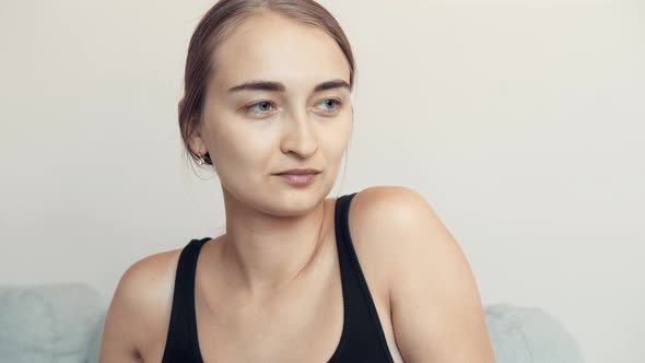 Young Woman Is Staring To The Side (Closeup Shot)