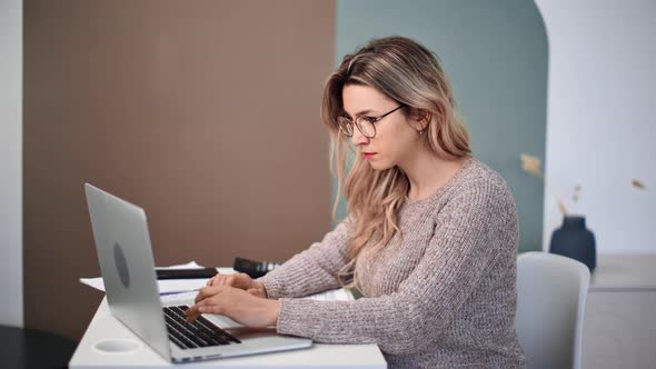 Focused Modern Woman Chatting Surfing Internet Use Laptop Sitting on Desk