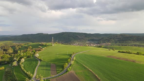 Sunset field and meadow near scenic village before storm. Spring drone 4k footage, Czechia