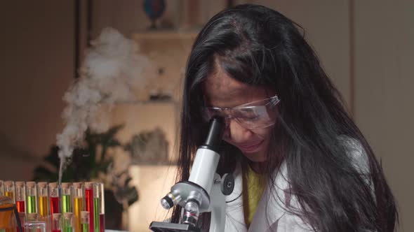 Excited Young Asian Scientist Girl With Dirty Face Looking At Microscope And Say Wow