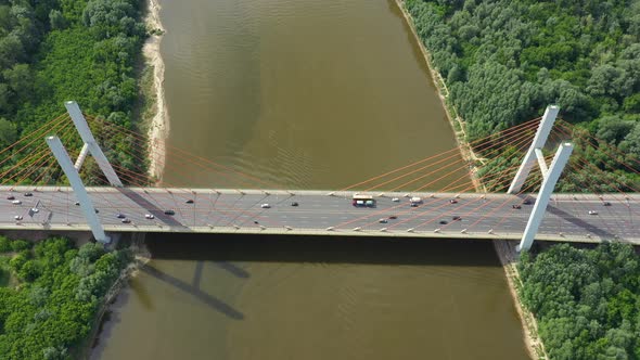 Aerial or top view from drone of concrete bridge with asphalt road or highway over big river with ci