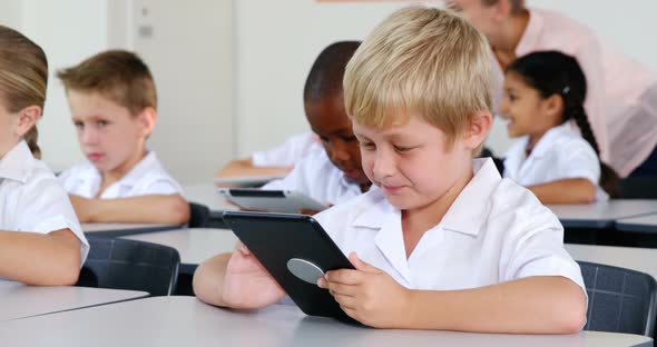 Schoolkids using digital tablet in classroom