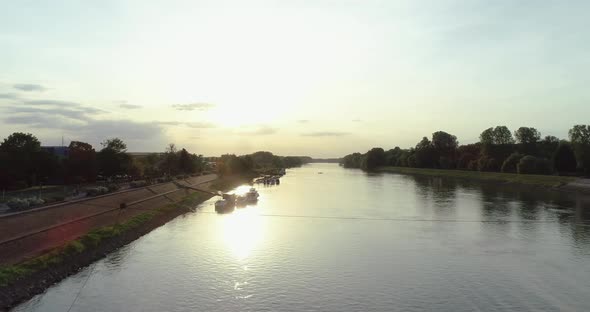 Aerial view of a small boat crossing Drava river at sunset, Osijek, Croatia.