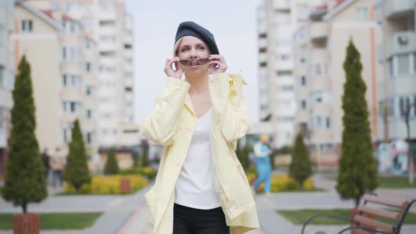 Beautiful Confident Blond Woman Walking and Taking Off Sunglasses. Portrait of Elegant Caucasian